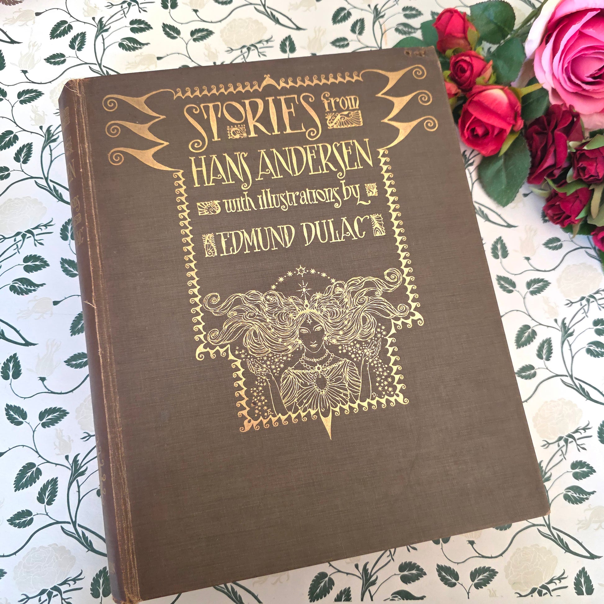 Decorative antique book in green cloth with gilt decoration, titled 'Stories from Hans Andersen' with illustrations by Edmund Dulac.