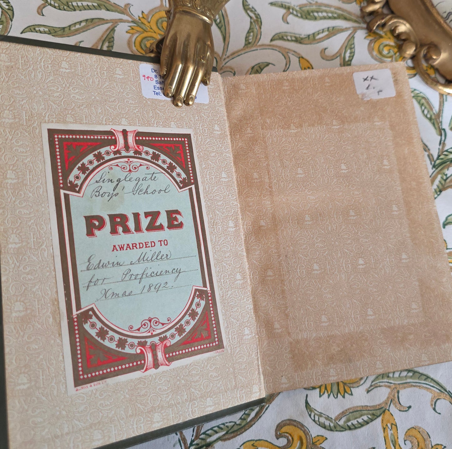 Decorative item with a vintage-style 'Prize' certificate on a patterned surface