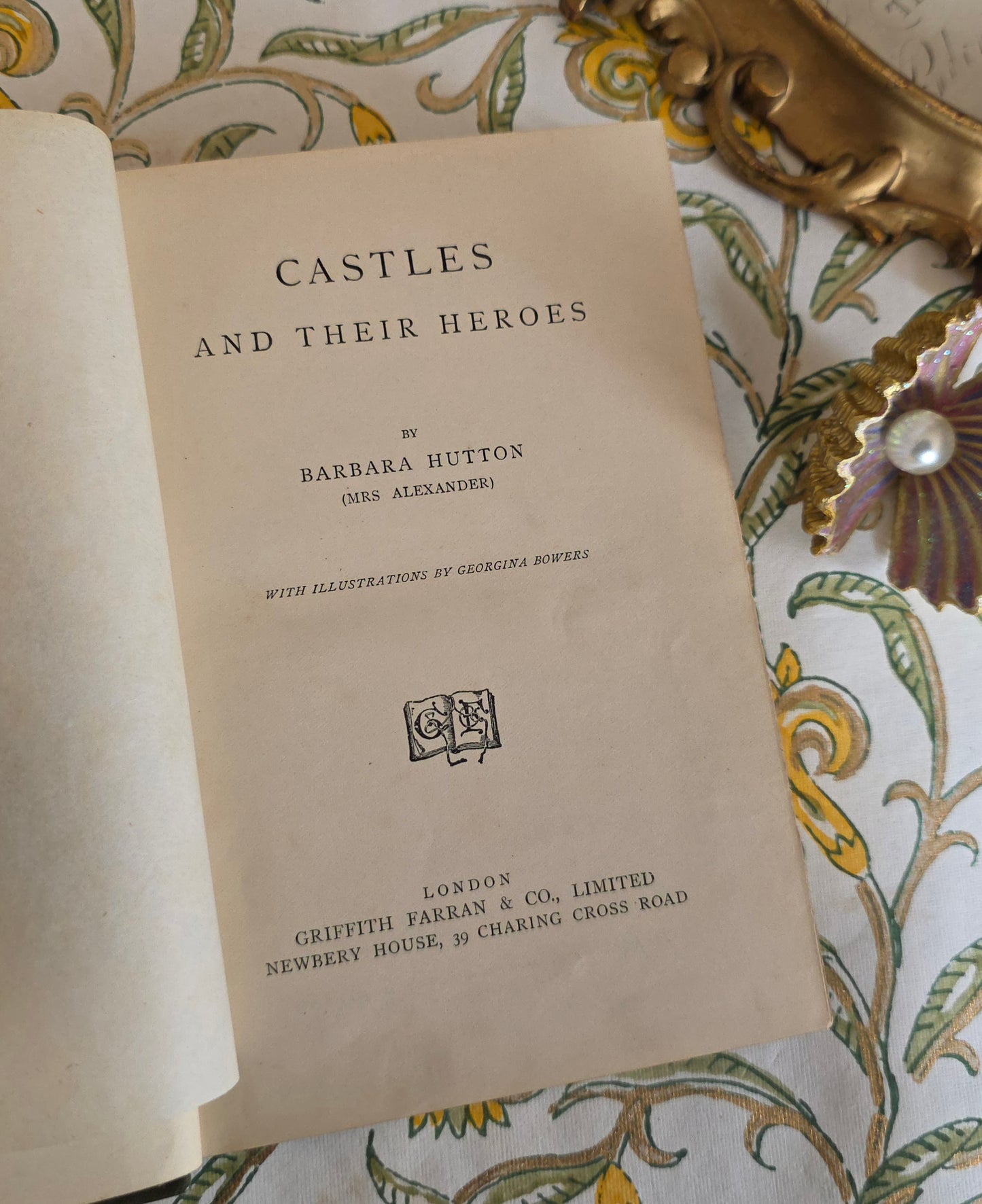 Title page of a book titled 'Castles and Their Heroes' by Barbara Hutton on a decorative background.