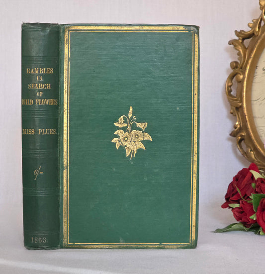Victorian green cloth bound book with gold floral design and title Rambles in Search of Wild Flowers 