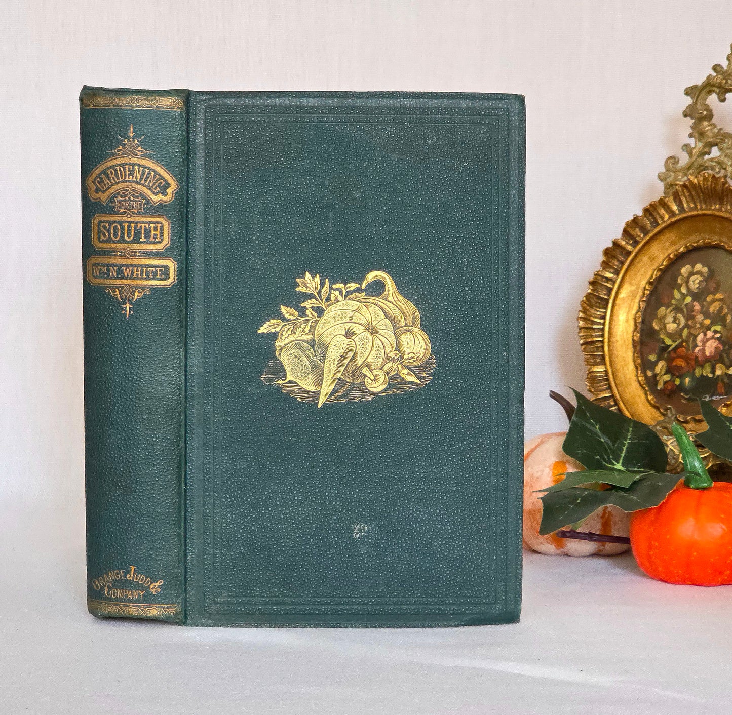 Antique book in green cloth with gilt decoration and titles saying 'Gardening For the South'