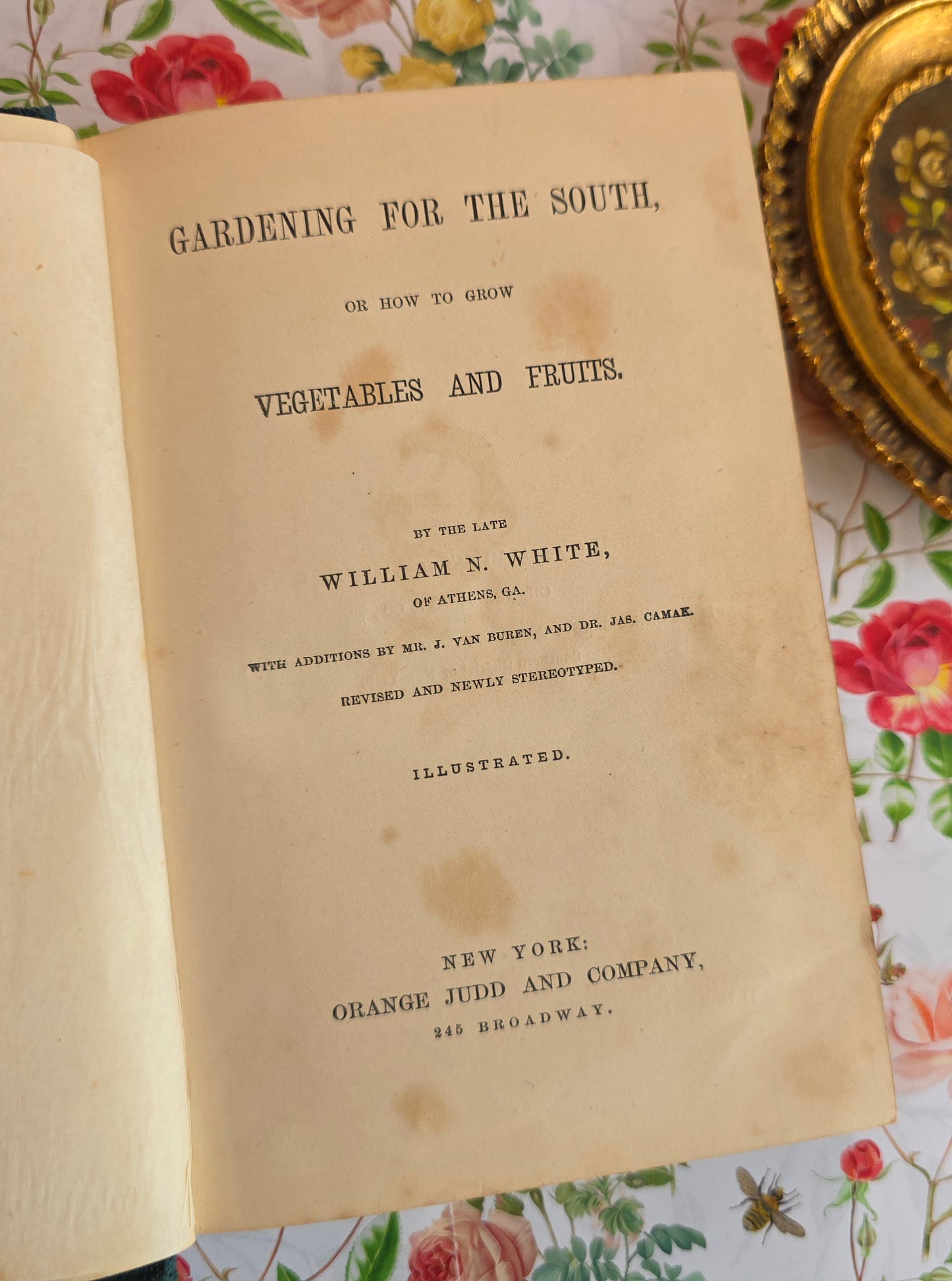 Vintage book titled 'Gardening for the South' on a floral-patterned surface