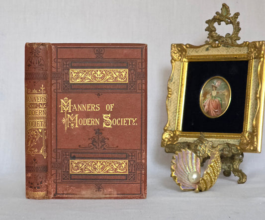 Antique book titled 'Manners of Modern Society' in brown cloth with gilt letters.