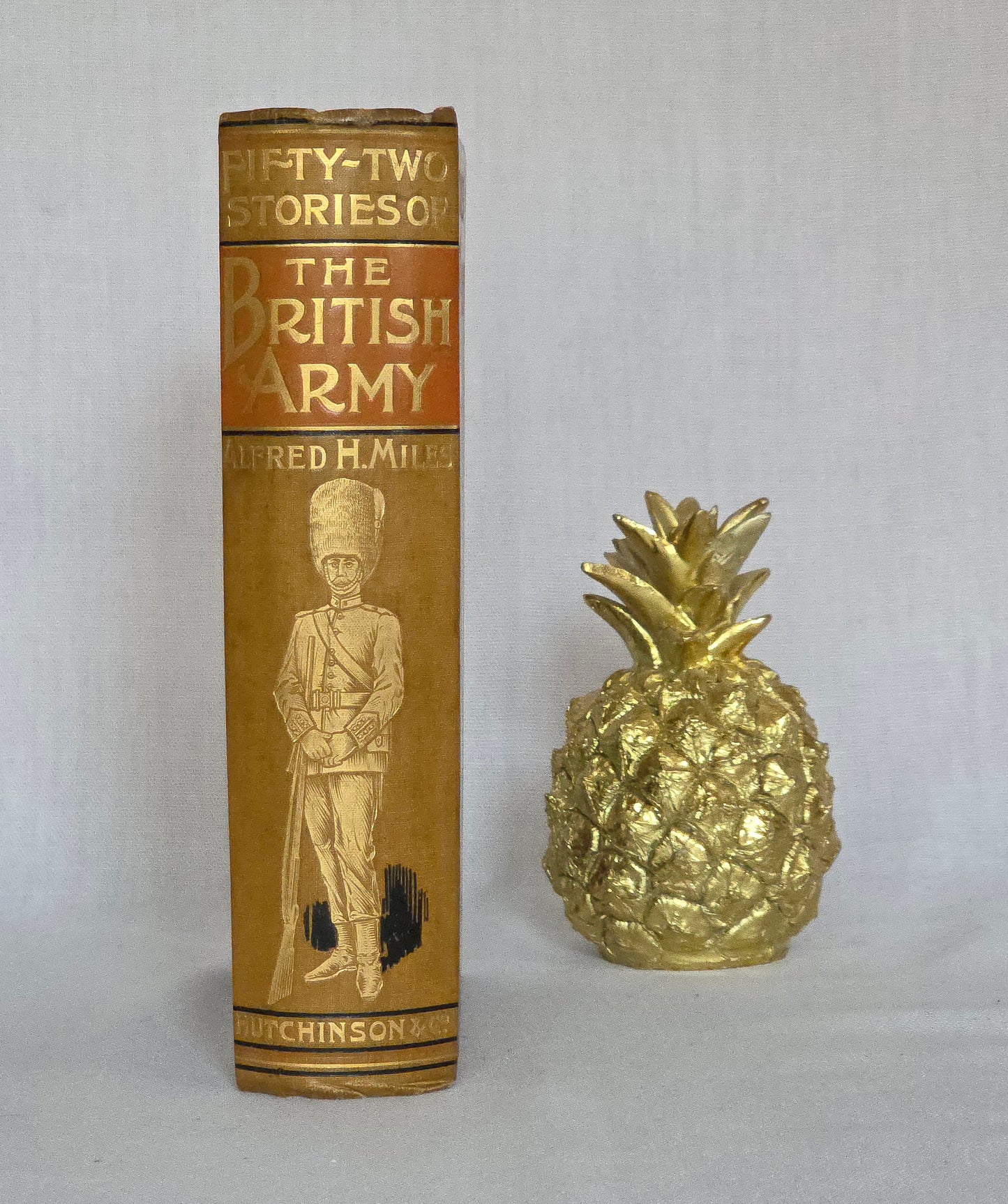 Antique book spine titled '52 Stories of the British Army' by Alfred H. Miles with a decorative cover illustration on a light gray background.