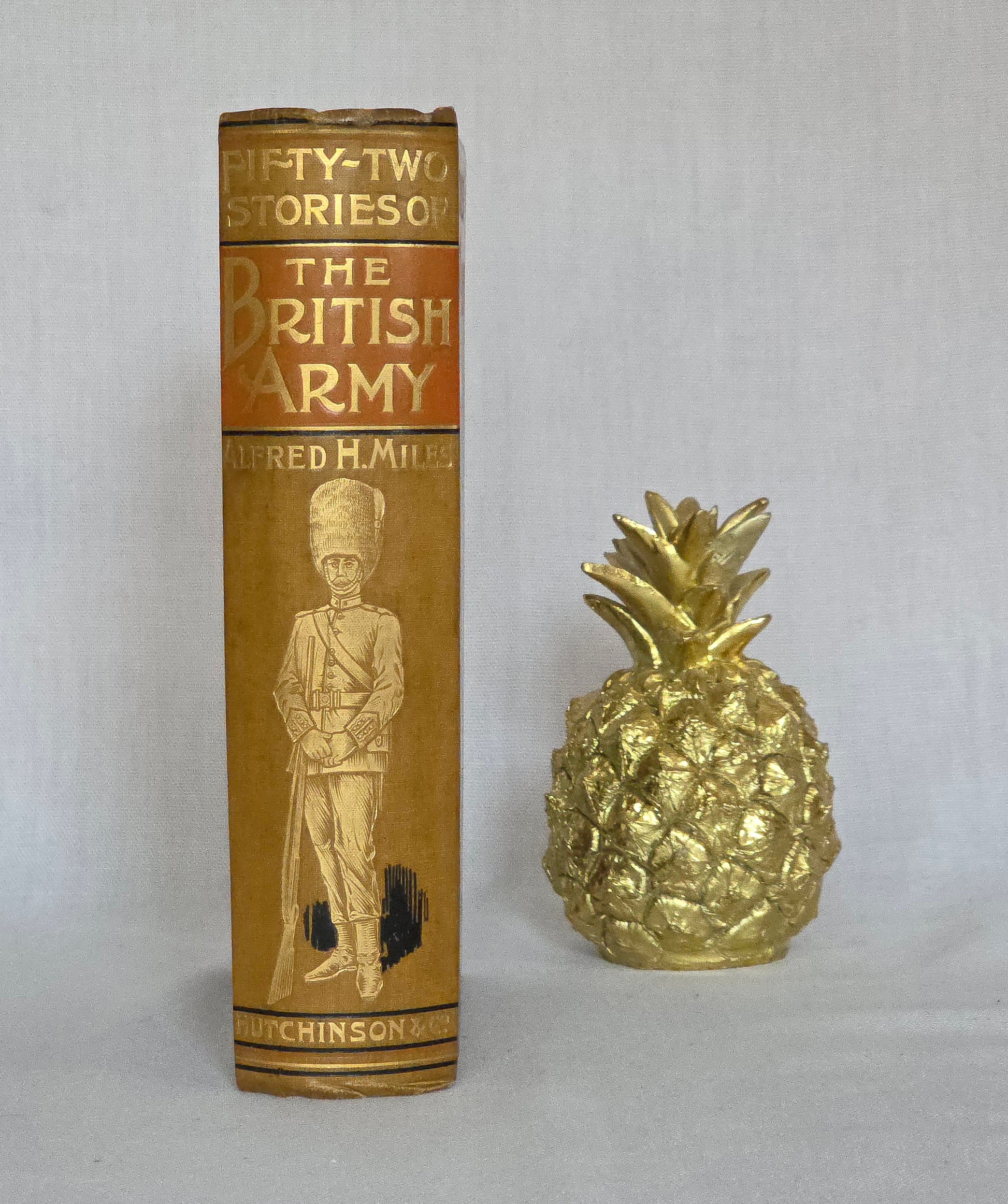 Antique book spine titled '52 Stories of the British Army' by Alfred H. Miles with a decorative cover illustration on a light gray background.