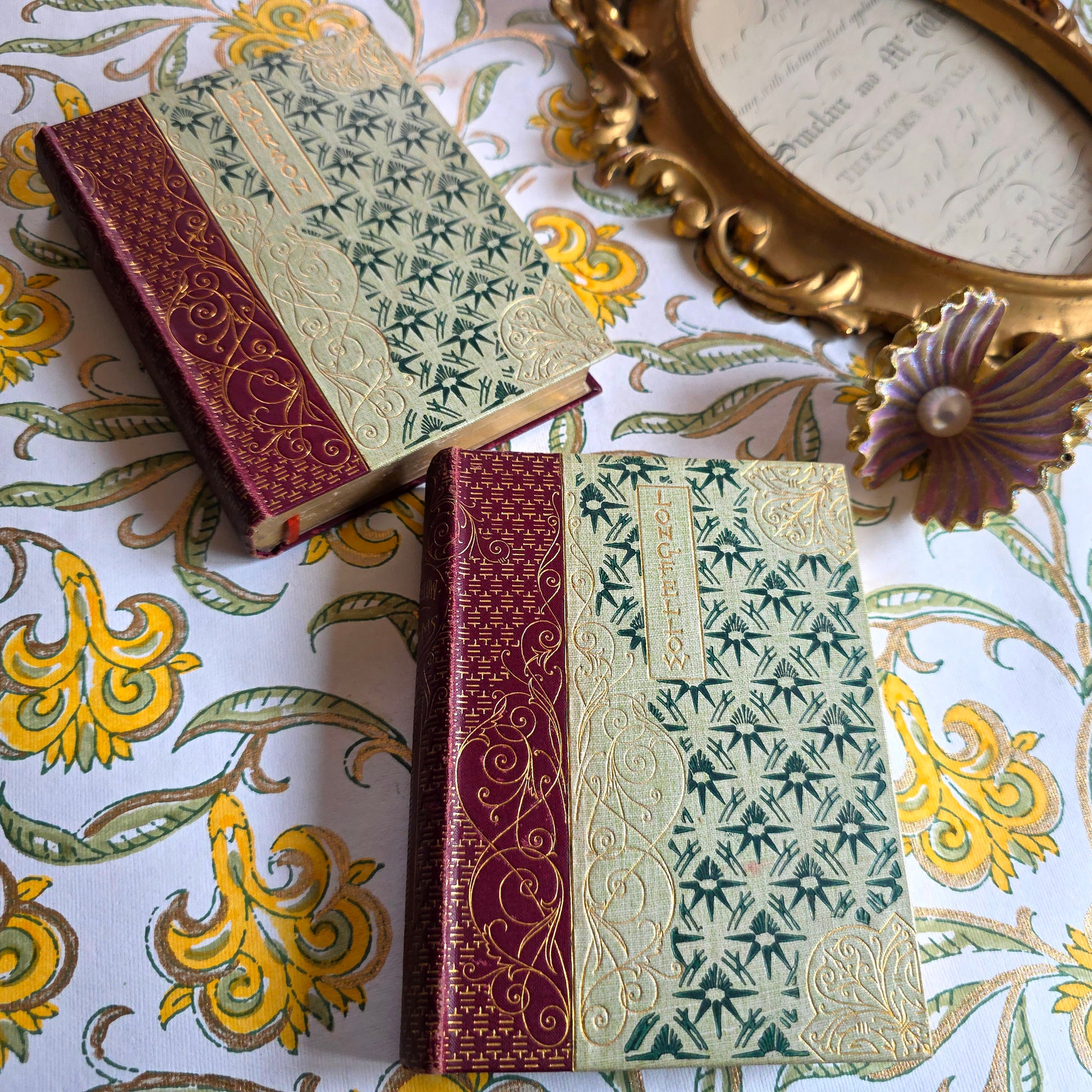 Two antique poetry books with decorative covers in a Chinoiserie and Art Nouveau style, Longfellow and Emerson in the Walter Scott Library 