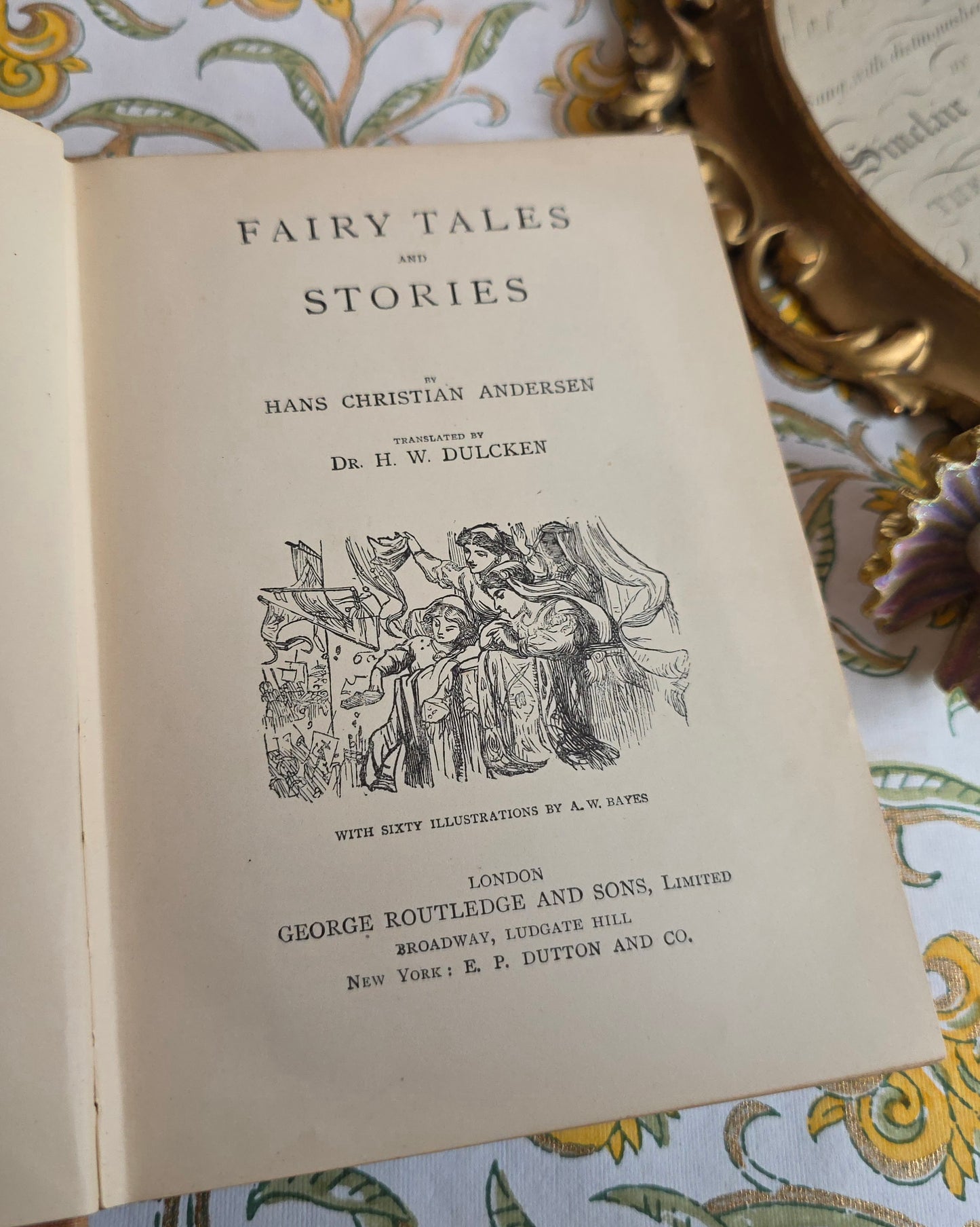Open antique book showing title page of Fairy Tales and Stories  by Hans Christian Andersen.