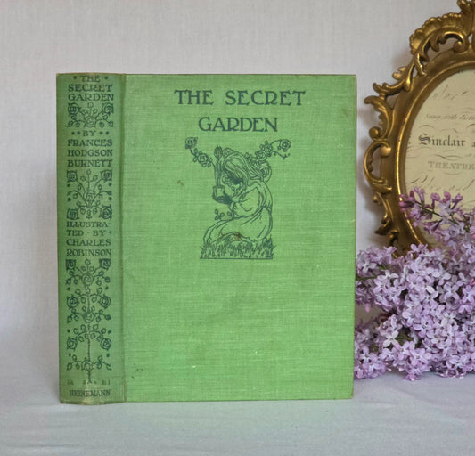 Vintage book titled 'The Secret Garden' by Frances Hodgson Burnett with decorative cover and floral elements.