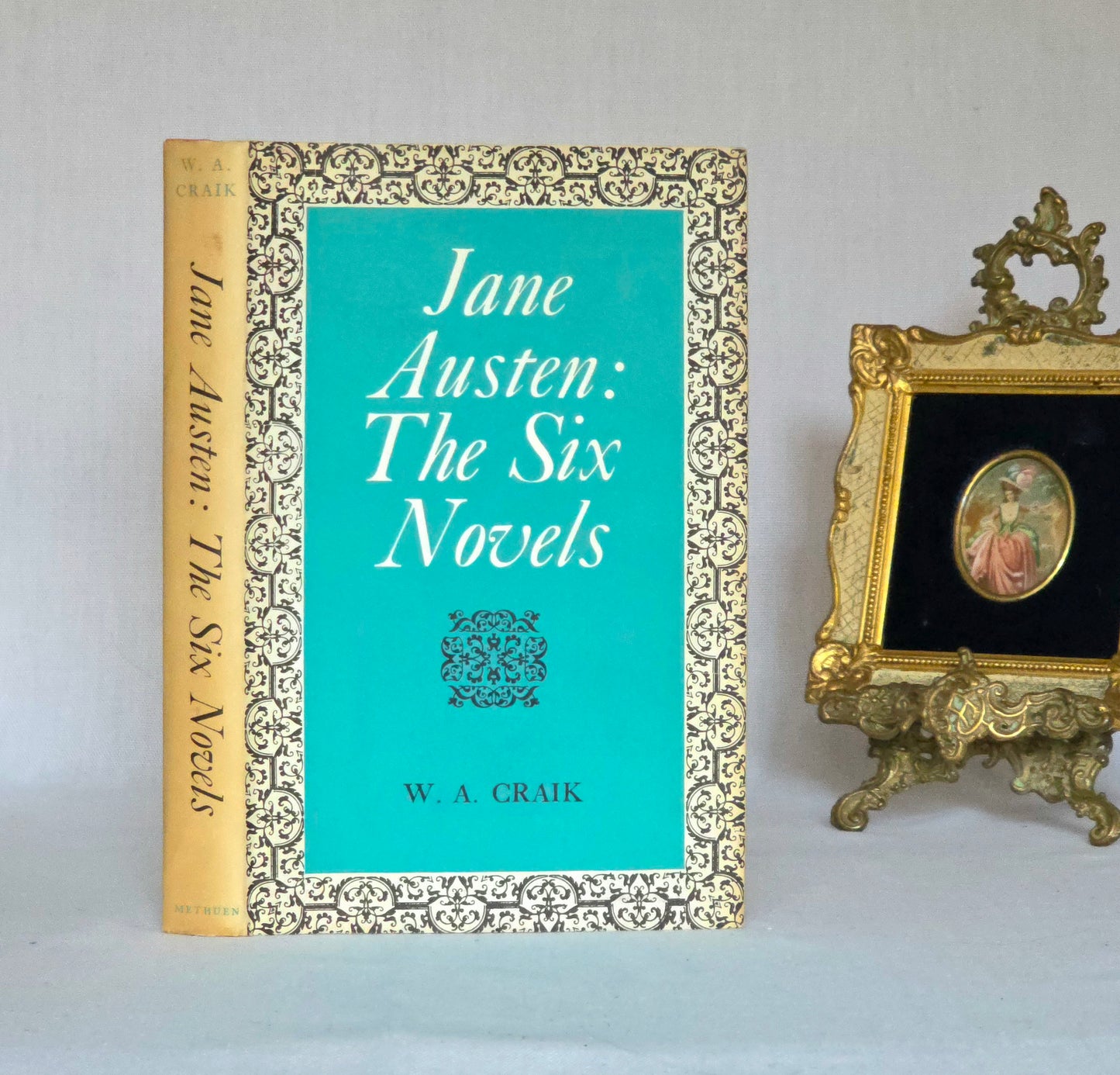 Book titled 'Jane Austen: The Six Novels' by W.A. Craik with decorative cover and gold frame.
