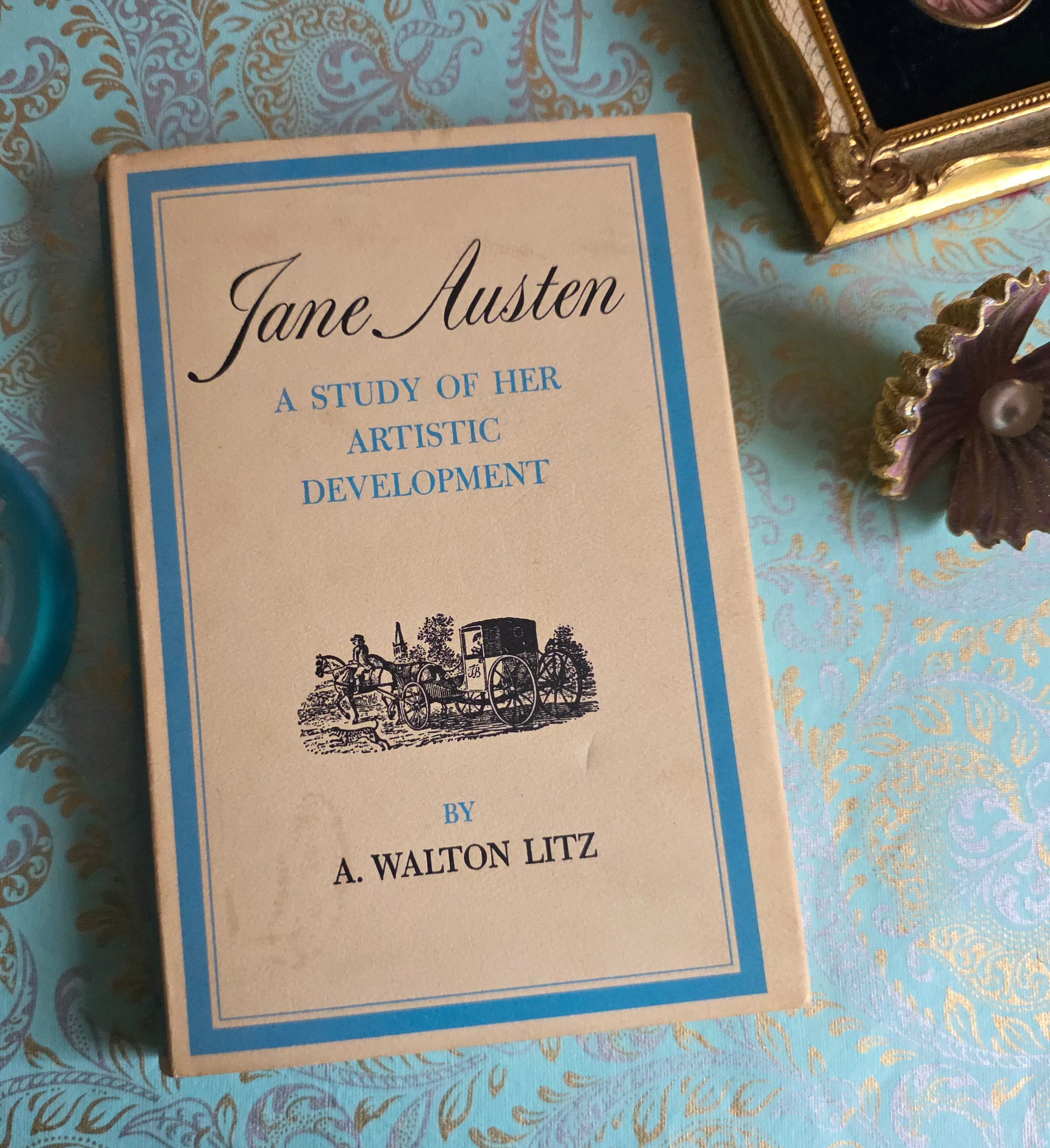 Book titled 'A Study of Her Artistic Development' by A. Walton Litz on a decorative surface