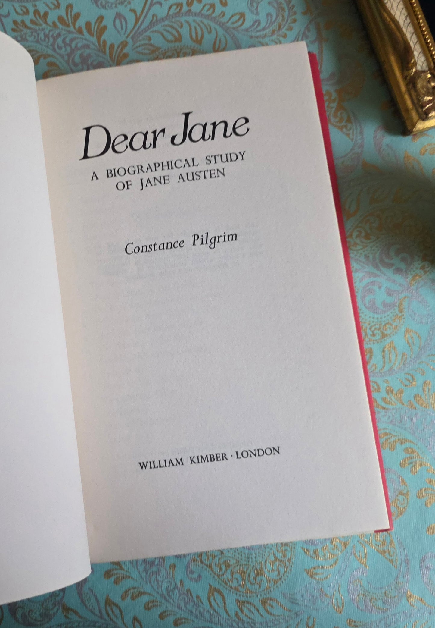 Book open at title page saying 'Dear Jane' by Constance Pilgrim on a decorative surface